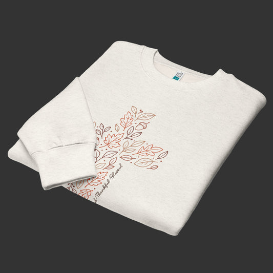 Folded Front view of neutral crewneck sweatshirt with seasonal cross graphic