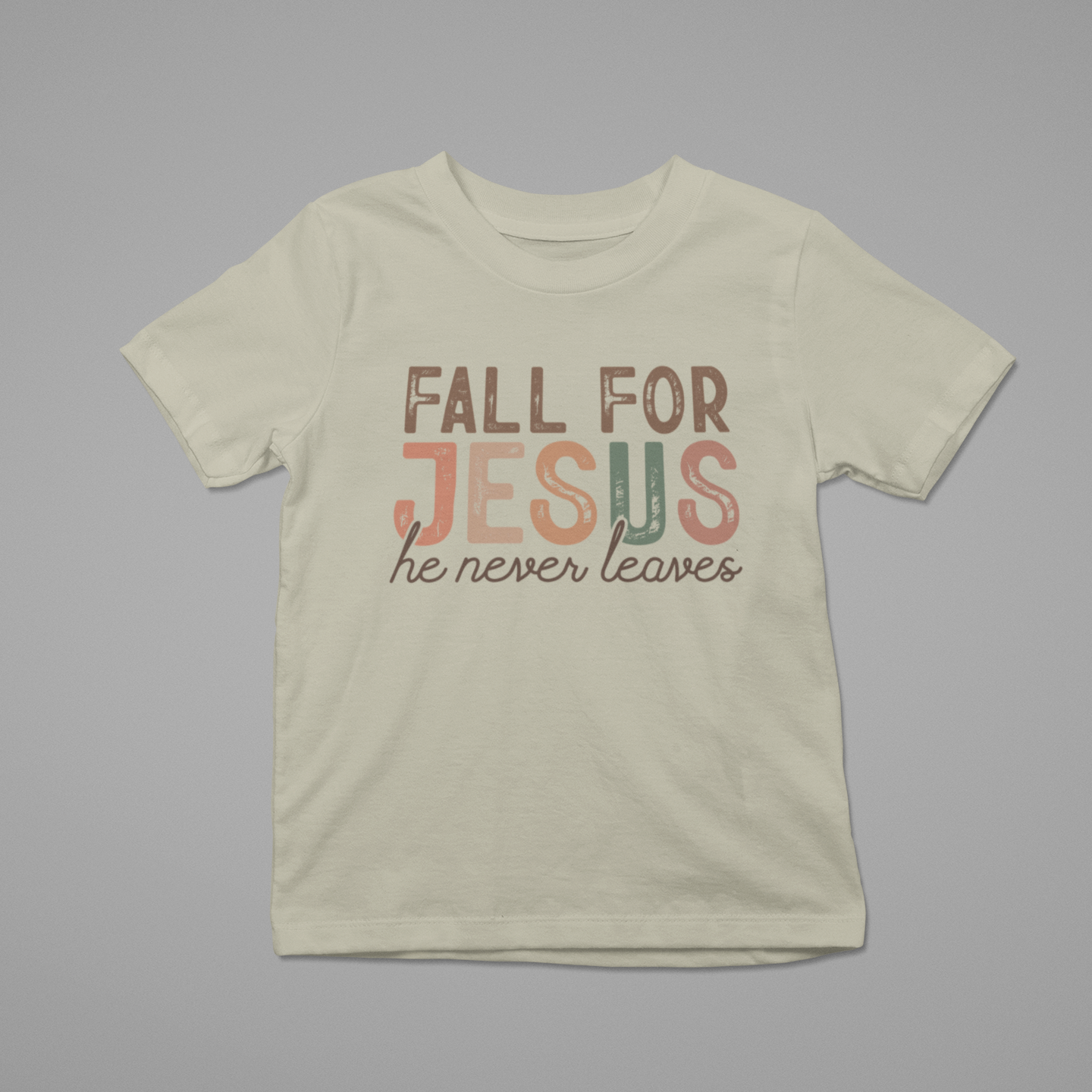 Beige t-shirt with 'Fall for Jesus he never leaves' text on a gray background